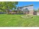Enjoy a large, green backyard with a covered patio, mature trees, and a lovely bird bath feature at 3270 S Krameria St, Denver, CO 80222
