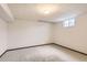 Unfinished basement area with neutral carpet and a small window at 3270 S Krameria St, Denver, CO 80222