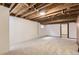 Spacious unfinished basement featuring exposed wood beams and white-painted walls at 3270 S Krameria St, Denver, CO 80222