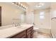 Updated bathroom with a large mirror, marble vanity, and a shower and tub combo at 3270 S Krameria St, Denver, CO 80222