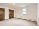 Bedroom offers soft carpet and natural light from a large window at 3270 S Krameria St, Denver, CO 80222