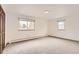 Large bedroom with neutral carpet, two windows, and a spacious closet at 3270 S Krameria St, Denver, CO 80222