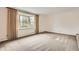 Bright living room with neutral carpet, large bay window with curtains, and fresh white walls at 3270 S Krameria St, Denver, CO 80222