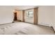 Bright living room with neutral carpet, large bay window with curtains, and fresh white walls at 3270 S Krameria St, Denver, CO 80222