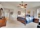 Spacious main bedroom features a ceiling fan, four poster bed, ensuite, and neutral carpet at 271 Las Lomas St, Brighton, CO 80601