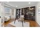 Home office featuring a large built-in bookcase and hardwood floors at 1124 W 124Th Ct, Westminster, CO 80234