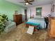 Spacious bedroom with multiple dressers, a ceiling fan, and a cozy chair at 12622 W Radcliff Ave, Morrison, CO 80465