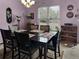 Traditional dining room with chandelier, window and furnishings on a patterned rug at 12622 W Radcliff Ave, Morrison, CO 80465