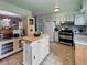 Spacious kitchen with a movable island and view to the dining and staircase at 12622 W Radcliff Ave, Morrison, CO 80465