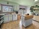 Functional kitchen featuring unique cabinets and a rolling island, creating a cozy cooking space at 12622 W Radcliff Ave, Morrison, CO 80465