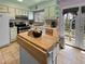 Charming kitchen with a rolling island, offering a flexible and functional cooking area at 12622 W Radcliff Ave, Morrison, CO 80465