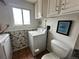 Functional laundry room with a washer, toilet, and white cabinetry for storage solutions at 12622 W Radcliff Ave, Morrison, CO 80465
