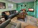 Living room featuring a fireplace, wood paneling, and a comfy sofa, perfect for relaxing at 12622 W Radcliff Ave, Morrison, CO 80465