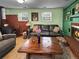 Cozy living room with wood stove, brick accent, a comfy sofa, and natural light at 12622 W Radcliff Ave, Morrison, CO 80465