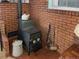 Corner wood stove with a brick surround and hearth at 12622 W Radcliff Ave, Morrison, CO 80465