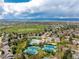 This aerial showcases the community, which includes tennis courts, a pool, and the nearby golf course at 7778 S Cherry Ct, Centennial, CO 80122