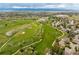 This aerial view reveals the neighborhood's beautiful golf course with mature trees and community buildings at 7778 S Cherry Ct, Centennial, CO 80122