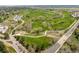 Expansive golf course and winding roads are showcased in this aerial view, surrounded by trees and fairways at 7778 S Cherry Ct, Centennial, CO 80122