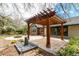Backyard features a wooden pergola with an outdoor patio and fireplace at 7778 S Cherry Ct, Centennial, CO 80122