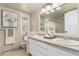 Updated bathroom with dual sinks, white vanity and framed mirror at 7778 S Cherry Ct, Centennial, CO 80122