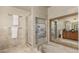 Luxurious bathroom features a soaking tub with brass fixtures, a framed mirror and shower at 7778 S Cherry Ct, Centennial, CO 80122