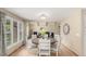 Bright dining room showcasing a large round table, wood floors, and ample natural light at 7778 S Cherry Ct, Centennial, CO 80122