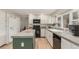 The kitchen features white cabinets, granite countertops, and modern appliances at 7778 S Cherry Ct, Centennial, CO 80122