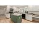 Updated kitchen with granite countertops, white cabinets, and a central island at 7778 S Cherry Ct, Centennial, CO 80122