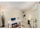 Well-lit home office featuring a desk, shelving, and a comfortable seating area at 7778 S Cherry Ct, Centennial, CO 80122