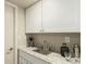 The wet bar showcases a granite countertop, cabinetry, sink, and drinkware for entertaining at 7778 S Cherry Ct, Centennial, CO 80122