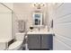 Modern bathroom features patterned wallpaper, a gray vanity, and a glass-enclosed shower at 10119 Bellwether Ln, Lone Tree, CO 80124