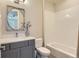 Neutral bathroom with a gray vanity and white tiled shower and tub at 10119 Bellwether Ln, Lone Tree, CO 80124