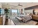 Bright bedroom with a balcony, scenic views, a ceiling fan, and a luxurious upholstered bed at 10119 Bellwether Ln, Lone Tree, CO 80124
