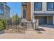 Close-up view of the entrance of a modern home with stone, wood, and a brick driveway at 10119 Bellwether Ln, Lone Tree, CO 80124