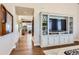 Hallway view showcases an open floorplan flowing to other living spaces and stylish built-in cabinetry at 10119 Bellwether Ln, Lone Tree, CO 80124