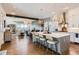 Open-concept kitchen with a large island, pendant lighting, and seamless flow to the living room at 10119 Bellwether Ln, Lone Tree, CO 80124