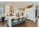 Bright kitchen featuring white cabinets, an island with marble countertop and seating for five at 10119 Bellwether Ln, Lone Tree, CO 80124