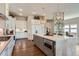 Bright kitchen featuring white cabinets, an island with marble countertop and stainless steel appliances at 10119 Bellwether Ln, Lone Tree, CO 80124