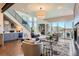 Bright living room with hardwood floors, modern decor, and sliding glass doors leading to a patio at 10119 Bellwether Ln, Lone Tree, CO 80124