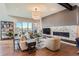 Bright living room with a fireplace and large windows providing plenty of natural light at 10119 Bellwether Ln, Lone Tree, CO 80124
