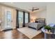 Comfortable main bedroom with a ceiling fan, natural light, and a plush rug at 10119 Bellwether Ln, Lone Tree, CO 80124
