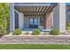 Outdoor patio with stone detailing overlooks manicured greenery, enhancing the property's curb appeal at 10119 Bellwether Ln, Lone Tree, CO 80124