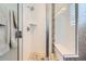 Modern glass shower with pebble floor, white tile and a built-in bench at 10119 Bellwether Ln, Lone Tree, CO 80124