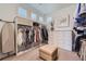 Spacious walk-in closet with custom shelving, storage, and a neutral-colored ottoman at 10119 Bellwether Ln, Lone Tree, CO 80124