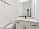 Bright, clean bathroom features a shower-tub combo and sleek vanity with modern hardware at 42986 Colonial Trl, Elizabeth, CO 80107