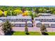 Townhome complex with garages surrounded by mature trees and lawns under a blue sky at 7589 S Cove Cir, Centennial, CO 80122