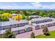 Aerial view of a townhome complex with well-maintained roofs, garages, and mature trees surrounding the property at 7589 S Cove Cir, Centennial, CO 80122