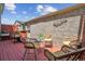 Outdoor deck area with wicker furniture, brick wall, and a planter box at 7589 S Cove Cir, Centennial, CO 80122