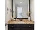 Charming bathroom vanity with granite countertop, black fixtures, and decor at 7589 S Cove Cir, Centennial, CO 80122