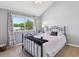 Bedroom features a black iron bed frame, soft carpet, and a window with view of greenery at 7589 S Cove Cir, Centennial, CO 80122